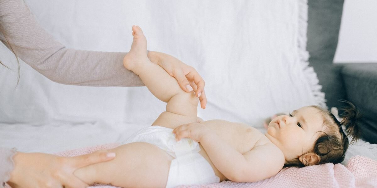 Ouder verzorgt de zachte, gevoelige huid van een baby