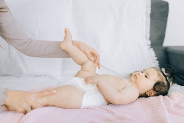 Ouder verzorgt de zachte, gevoelige huid van een baby