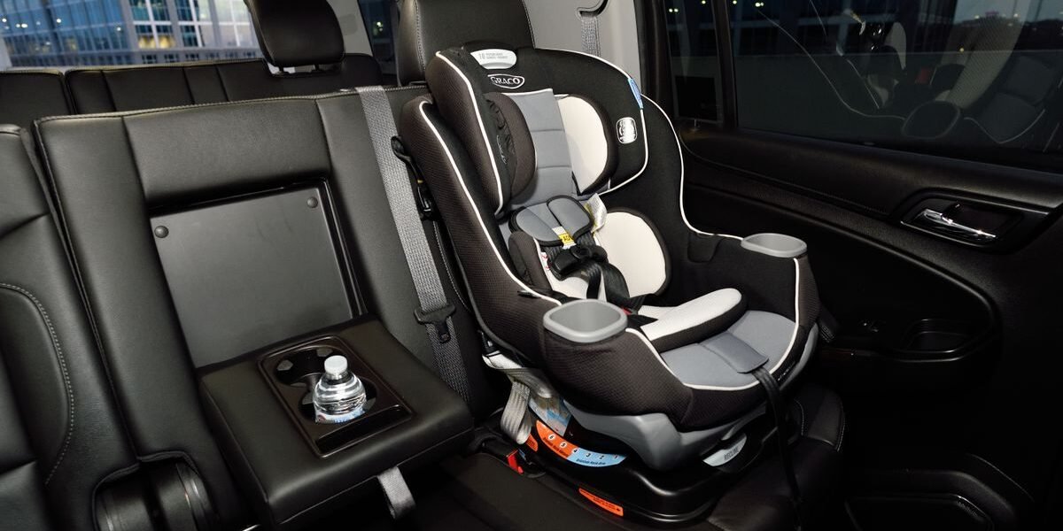 Baby in autostoel groep 0+ die op een kinderwagenonderstel wordt geklikt