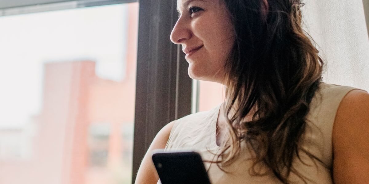 Zwangere vrouw vinkt baby uitzetlijst af op haar smartphone
